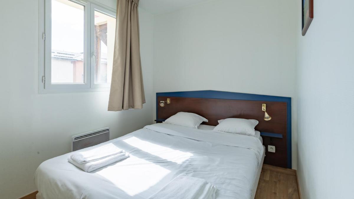 Un ou plusieurs lits dans un hébergement de l'établissement Vacancéole - Appart'Vacances Pyrénées 2000