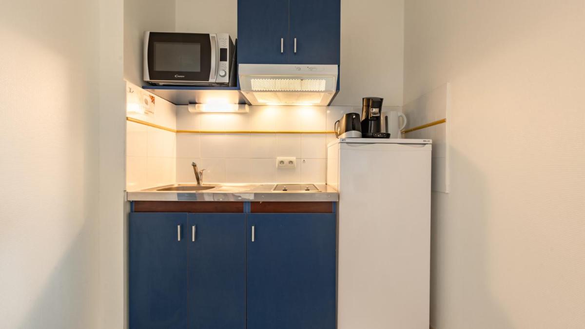 Cuisine ou kitchenette dans l'établissement Vacancéole - Appart'Vacances Pyrénées 2000