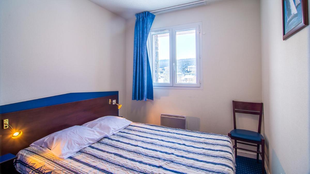 Un ou plusieurs lits dans un hébergement de l'établissement Vacancéole - Appart'Vacances Pyrénées 2000
