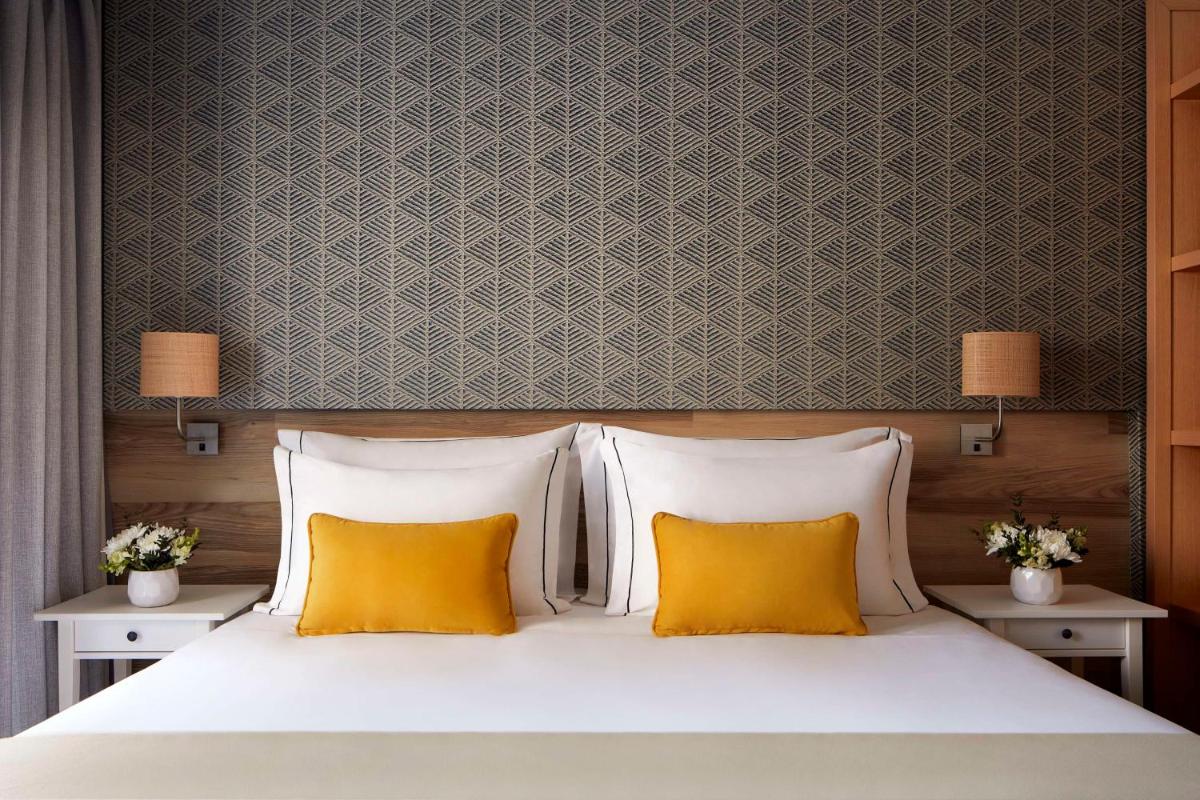 Uma cama ou camas num quarto em Tivoli Alvor Algarve - All Inclusive Resort