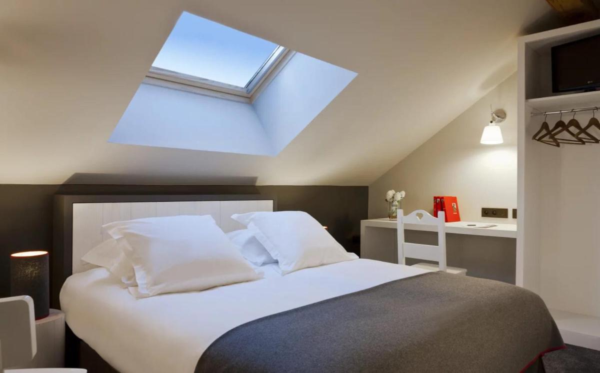 Un ou plusieurs lits dans un hébergement de l'établissement Le Faucigny - Hotel de Charme & SPA