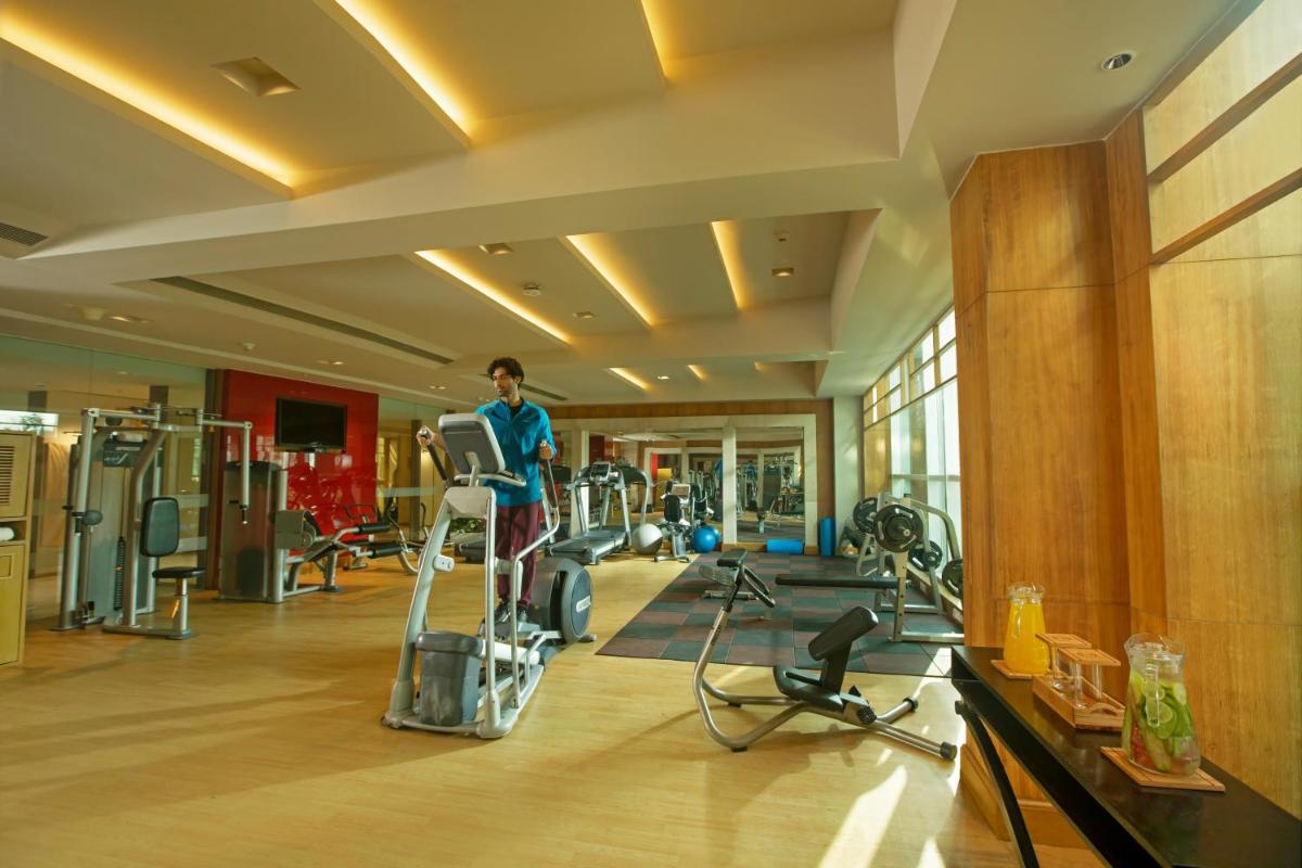 a man standing on a treadmill in a gym at Taj Agra in Agra