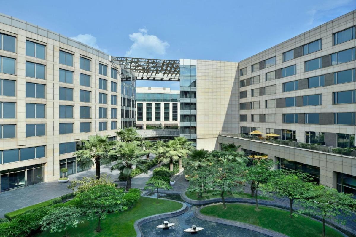an aerial view of a building with trees and buildings at JW Marriott Hotel New Delhi Aerocity in New Delhi an aerial view of a building with trees and buildings at JW Marriott Hotel New Delhi Aerocity in New Delhi