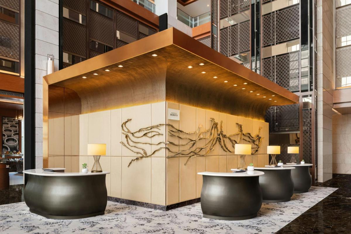 a lobby with a row of tables in a building at Sheraton Hyderabad Hotel in Hyderabad