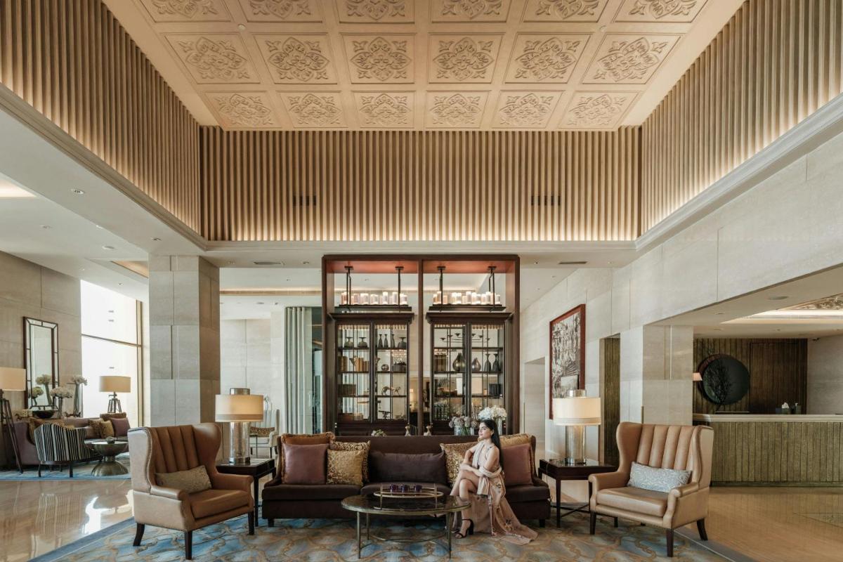 a lobby with couches and chairs and a table at JW Marriott Mussoorie Walnut Grove Resort & Spa in Mussoorie