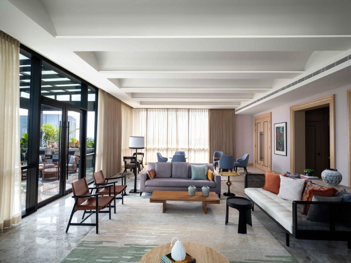 a living room with a couch and chairs at Pullman Chennai Anna Salai - Premium Brand By Accor in Chennai