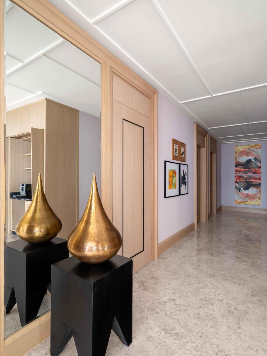 two gold vases sitting on tables in a room at Pullman Chennai Anna Salai - Premium Brand By Accor in Chennai