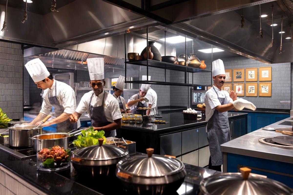 a group of chefs preparing food in a kitchen at Pullman Chennai Anna Salai - Premium Brand By Accor in Chennai