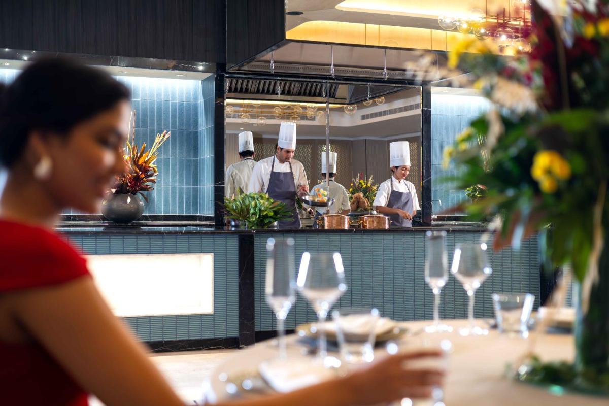 a group of chefs in a kitchen with wine glasses at Pullman Chennai Anna Salai - Premium Brand By Accor in Chennai