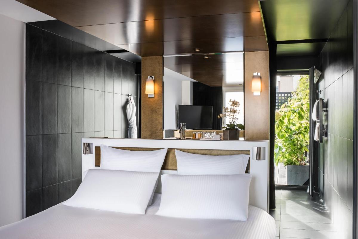 Un ou plusieurs lits dans un hébergement de l'établissement Boutet Bastille Hotel Paris - MGallery Collection