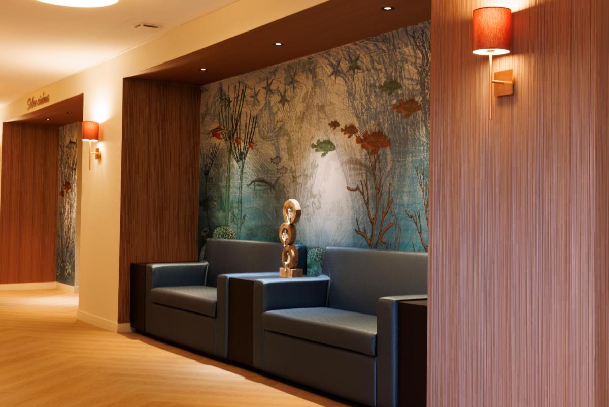 Coin salon dans l'établissement Les Boréales - Appart'hotel & Restaurant