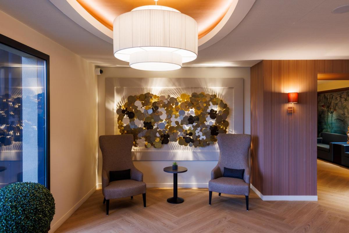Coin salon dans l'établissement Les Boréales - Appart'hotel & Restaurant