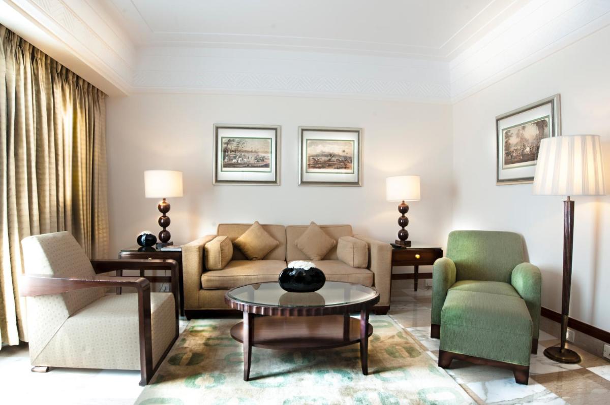 a living room with a couch and chairs and a table at The Imperial, New Delhi in New Delhi a living room with a couch and chairs and a table at The Imperial, New Delhi in New Delhi