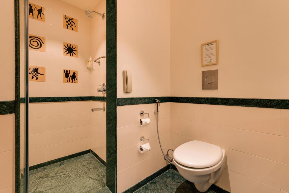 a bathroom with a toilet and a shower at Lemon Tree Premier Hitec City Hyderabad in Hyderabad