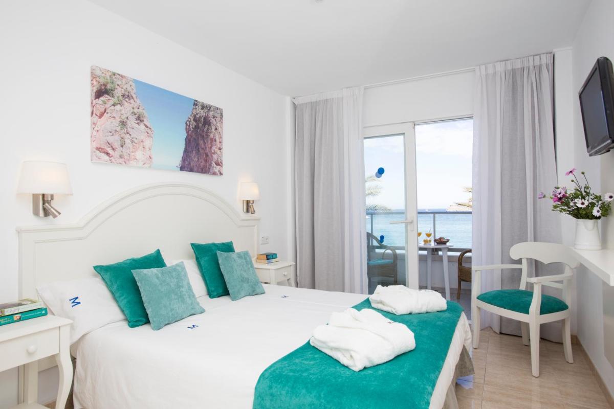 Cama o camas de una habitación en Hotel Marina