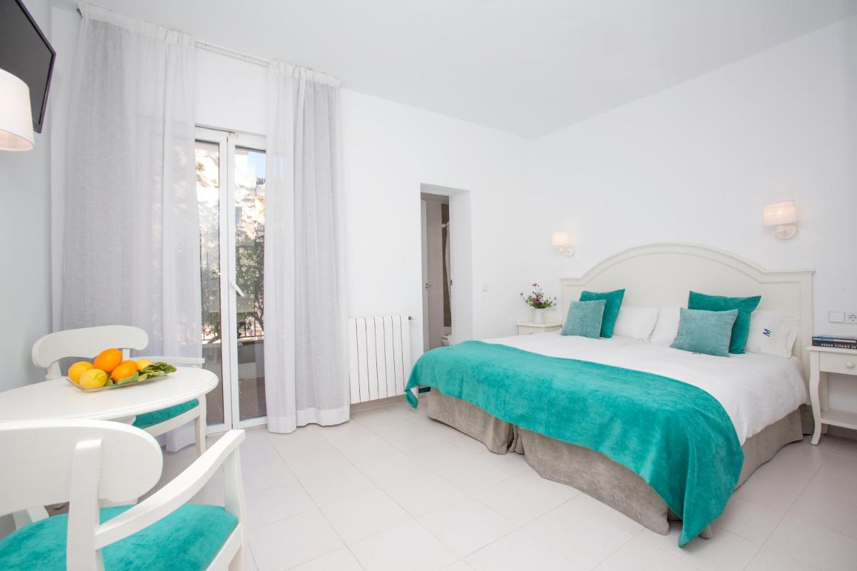 Cama o camas de una habitación en Hotel Marina