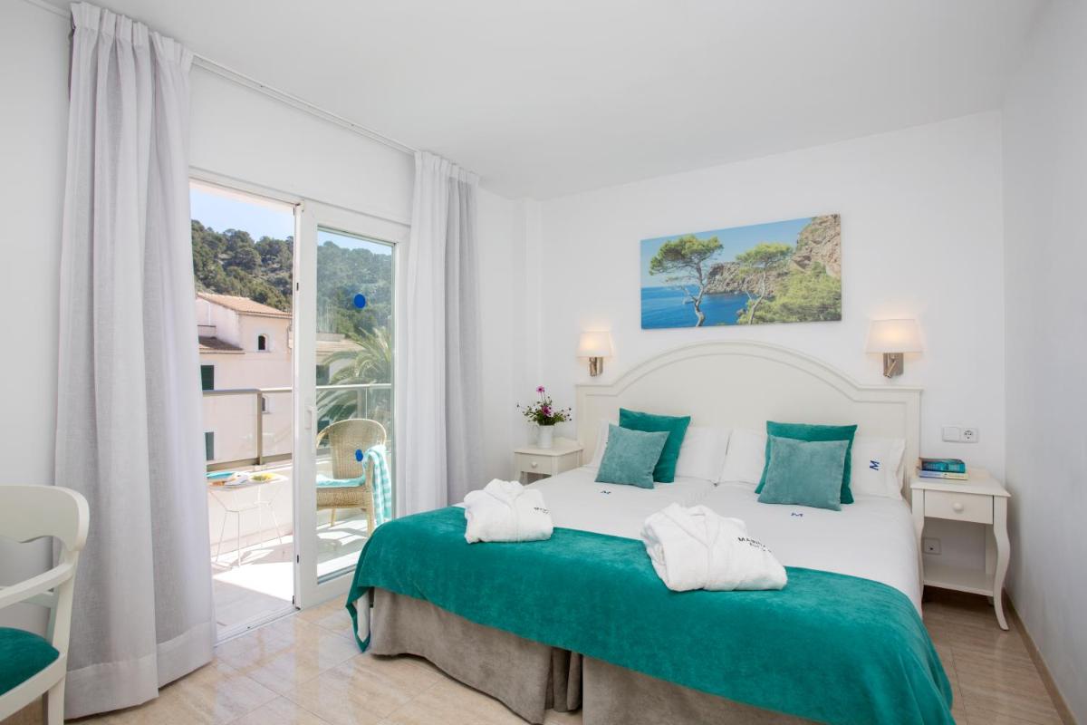 Cama o camas de una habitación en Hotel Marina