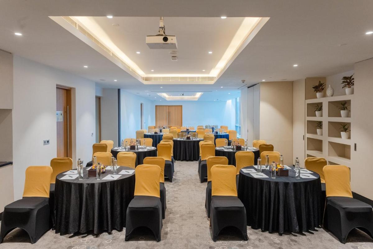 a conference room with tables and chairs in it at Holiday Inn Chennai OMR IT Expressway by IHG in Chennai