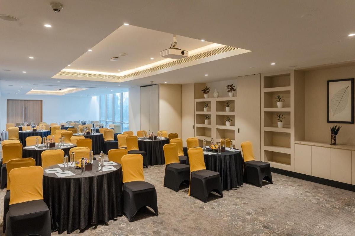 a conference room with tables and chairs in it at Holiday Inn Chennai OMR IT Expressway by IHG in Chennai