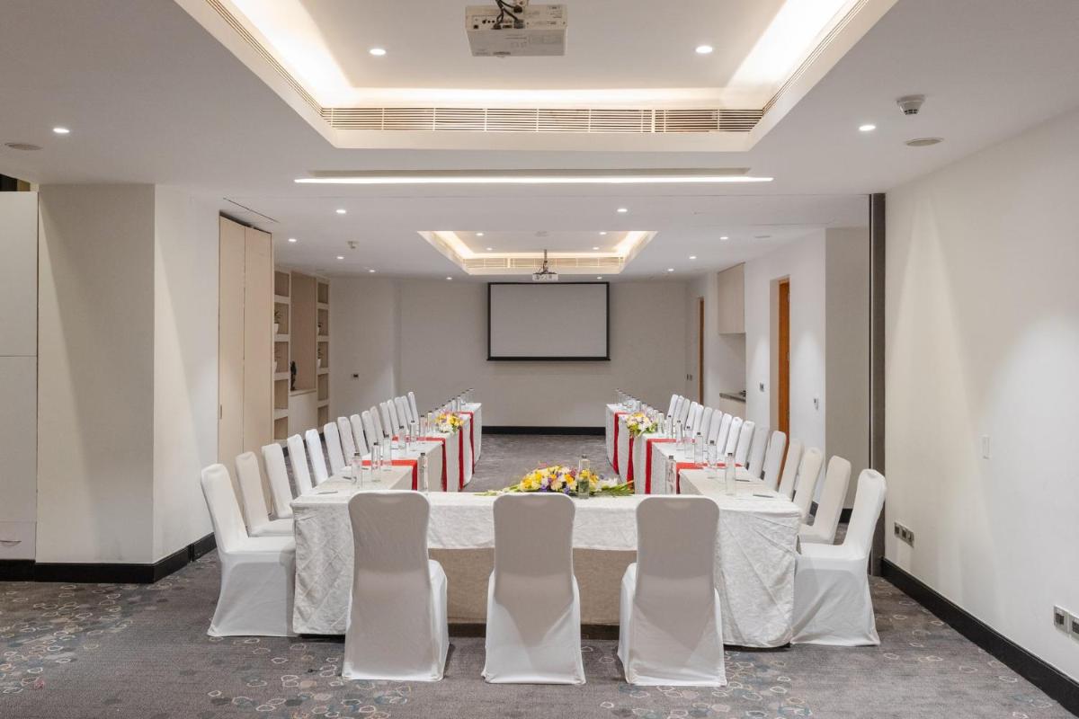 a conference room with a long table and white chairs at Holiday Inn Chennai OMR IT Expressway by IHG in Chennai
