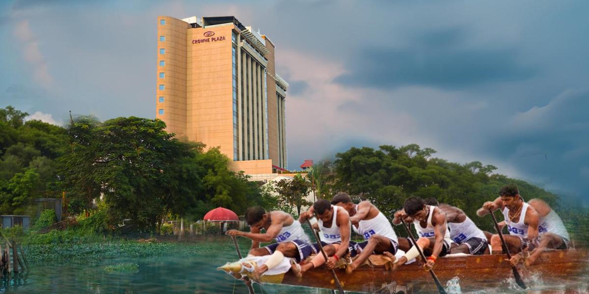 a group of people in a boat in the water at Crowne Plaza Kochi by IHG in Cochin