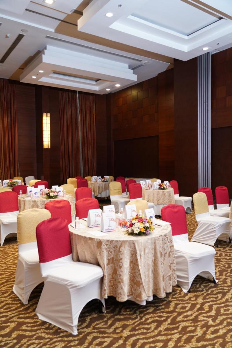 a conference room with tables and red and white chairs at Fortune Select JP Cosmos, Bengaluru - Member ITC Hotels' Group in Bengaluru