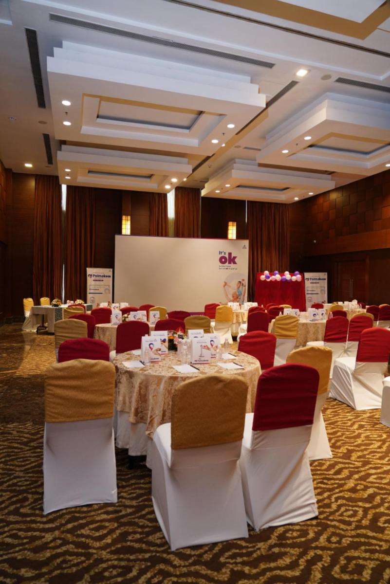 a banquet hall with white tables and red chairs at Fortune Select JP Cosmos, Bengaluru - Member ITC Hotels' Group in Bengaluru