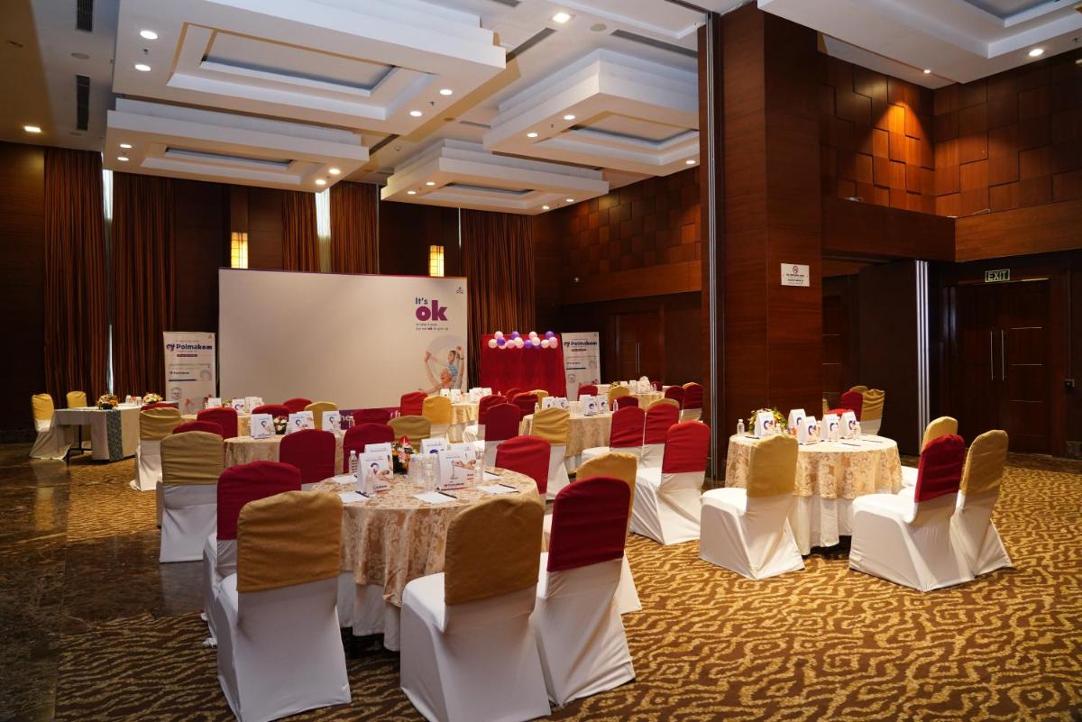 a conference room with tables and chairs and a screen at Fortune Select JP Cosmos, Bengaluru - Member ITC Hotels' Group in Bengaluru