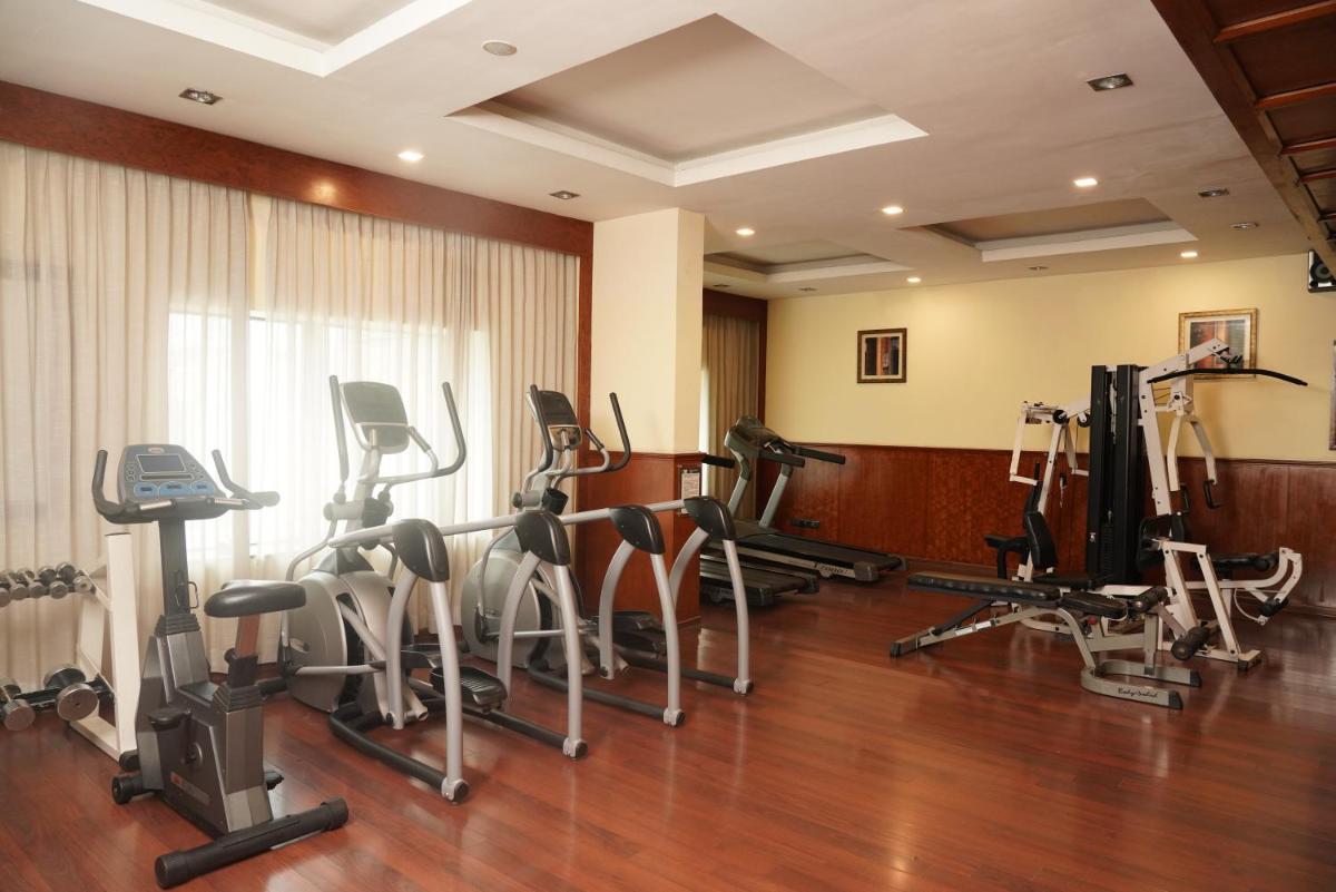 a gym with several treadmills and exercise bikes at Fortune Select JP Cosmos, Bengaluru - Member ITC Hotels' Group in Bengaluru
