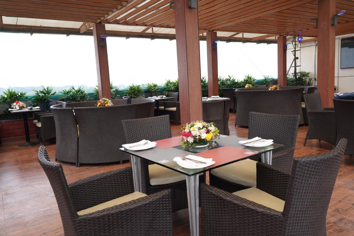 a dining room with a table and chairs at Fortune Select JP Cosmos, Bengaluru - Member ITC Hotels' Group in Bengaluru