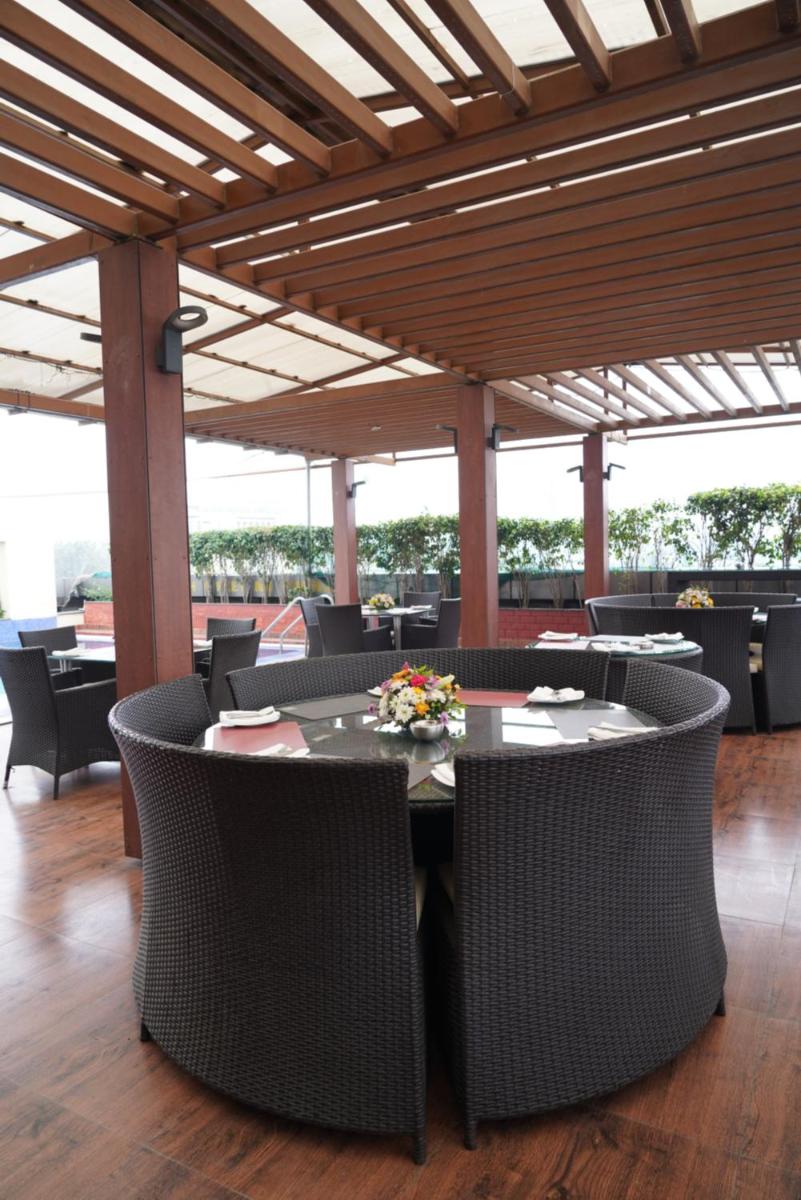 a dining room with a table and chairs in a building at Fortune Select JP Cosmos, Bengaluru - Member ITC Hotels' Group in Bengaluru