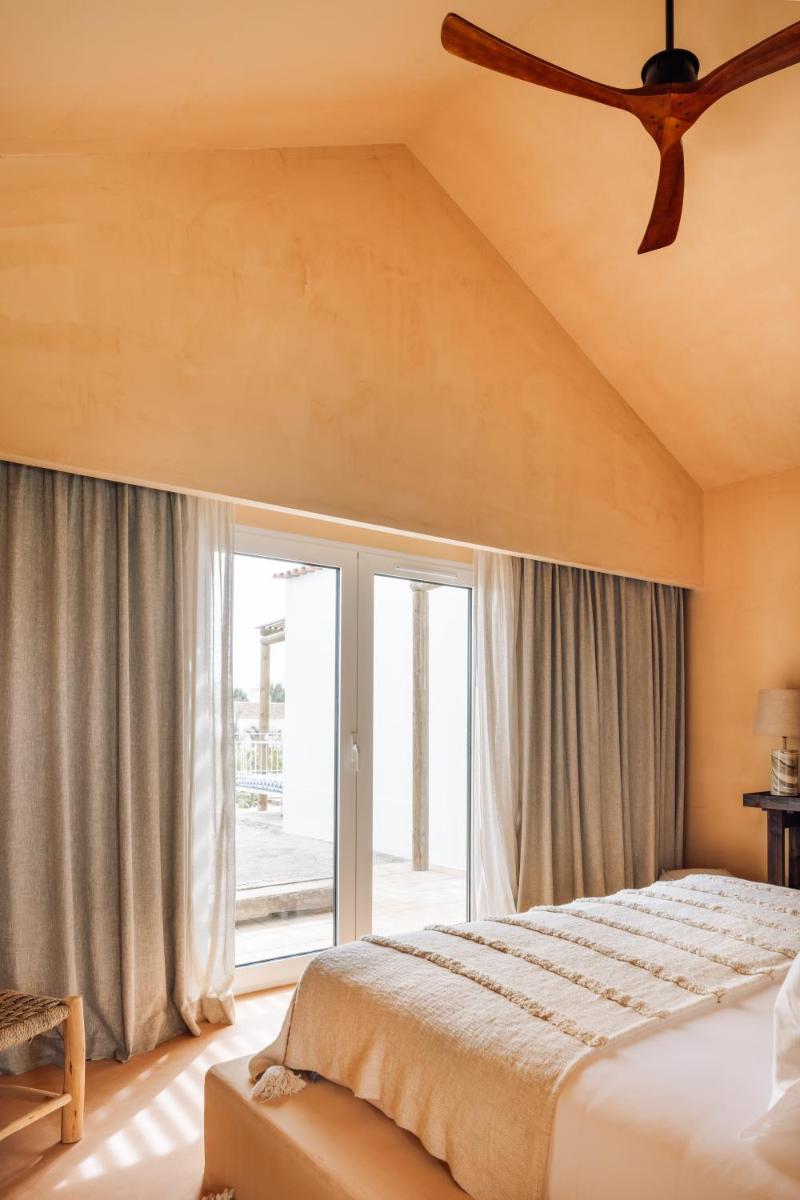 Uma cama ou camas num quarto em Independente Comporta