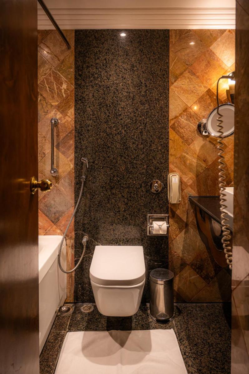 a bathroom with a toilet and a sink at The Park Kolkata in Kolkata