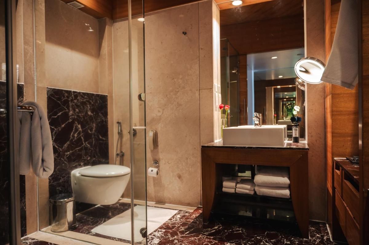 a bathroom with a toilet and a sink at The Park Kolkata in Kolkata