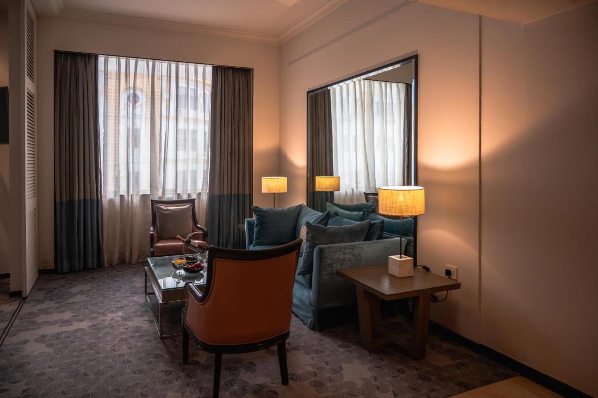 a hotel room with a couch and a table at The Park Kolkata in Kolkata