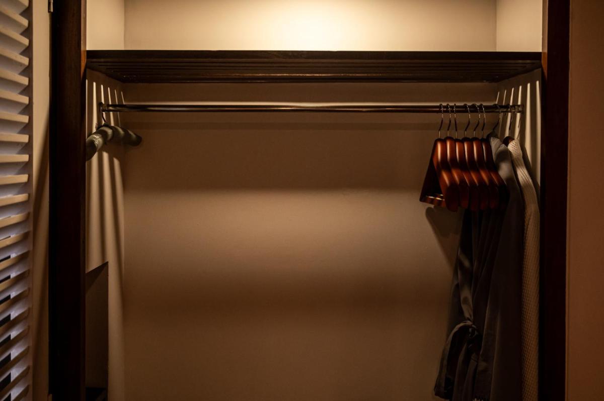 a closet with a door and a rack of clothes at The Park Kolkata in Kolkata
