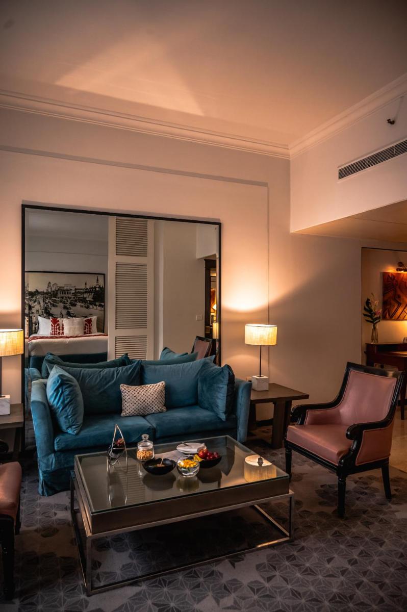 a living room with a blue couch and a table at The Park Kolkata in Kolkata