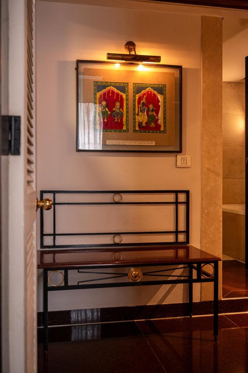 a bench in a room with a picture on the wall at The Park Kolkata in Kolkata