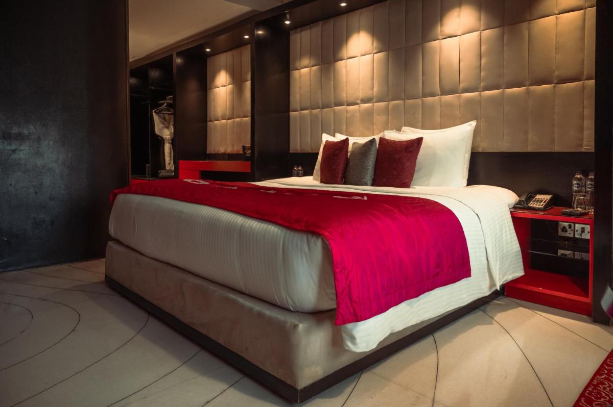 a bedroom with a large bed with a red blanket at The Park Kolkata in Kolkata