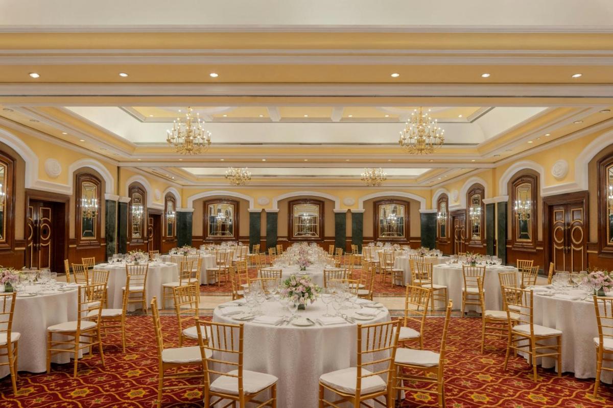a banquet hall with white tables and chairs and chandeliers at ITC Grand Central, a Luxury Collection Hotel, Mumbai in Mumbai
