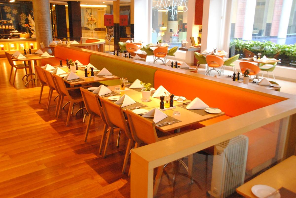 a restaurant with tables and chairs and a bar at Taj Chandigarh in Chandīgarh