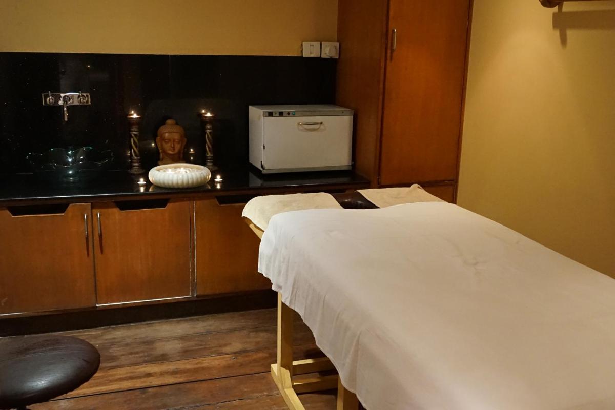 a hospital room with a bed and a microwave at Taj Chandigarh in Chandīgarh