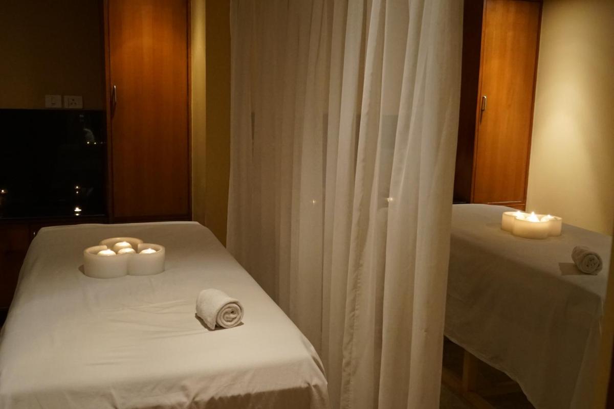 a room with two beds with candles and towels at Taj Chandigarh in Chandīgarh