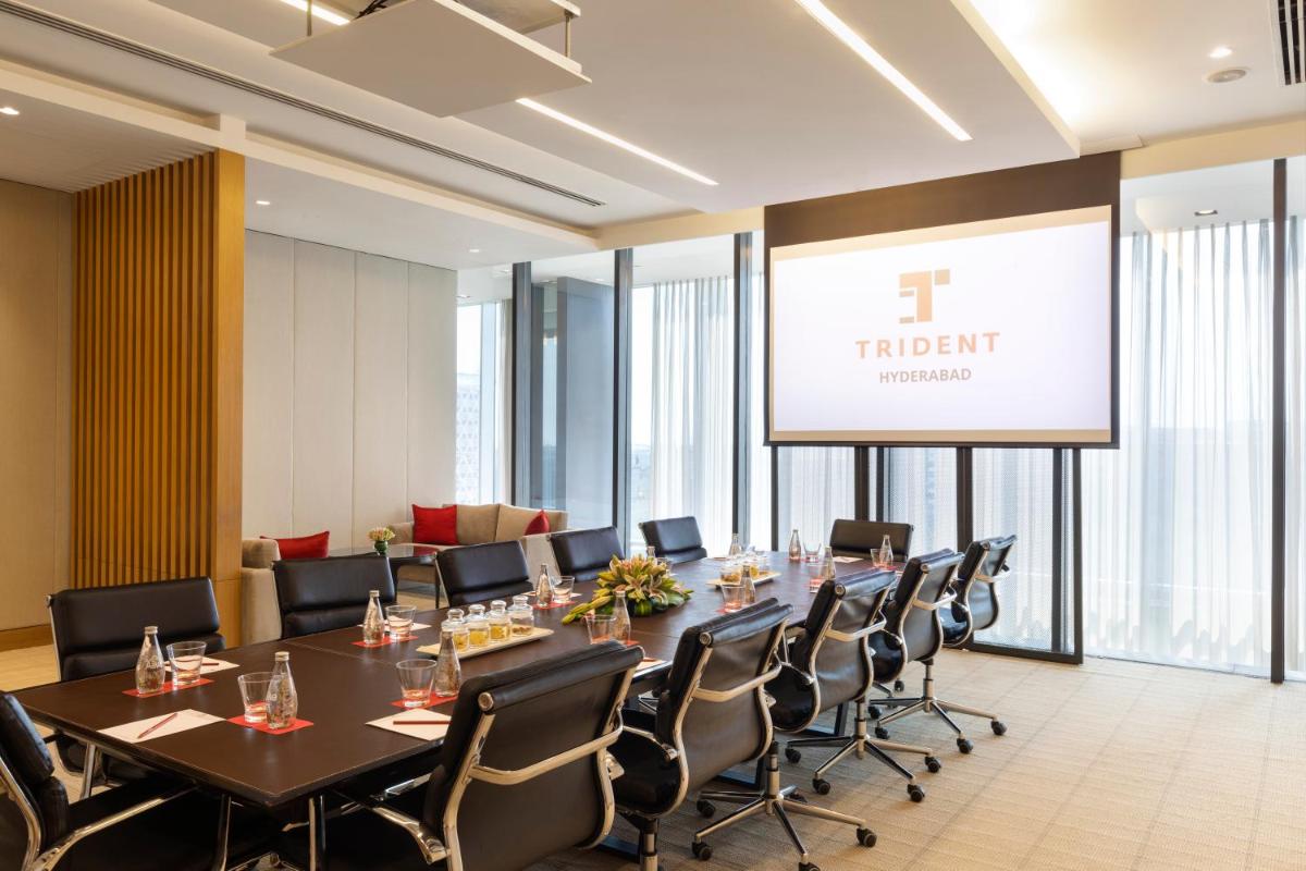 a conference room with a long table and chairs at Trident Hyderabad in Hyderabad