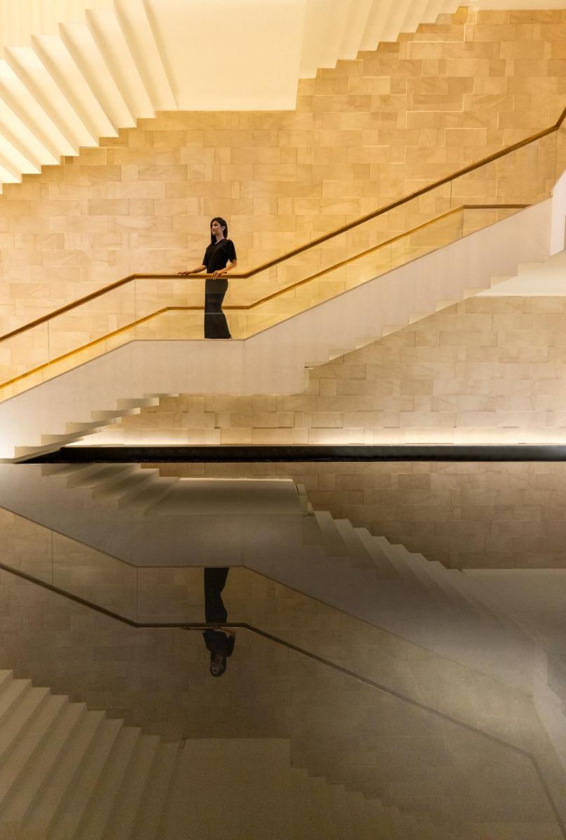 a man sitting on the stairs of a building at Trident Hyderabad in Hyderabad