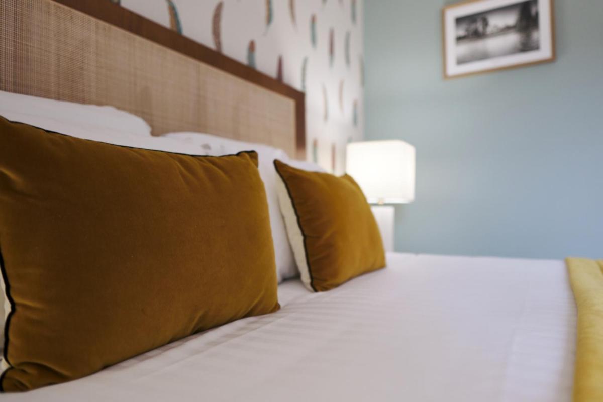 Un ou plusieurs lits dans un hébergement de l'établissement Domaine Du Roncemay - Hôtel, Restaurants, Spa & Golf
