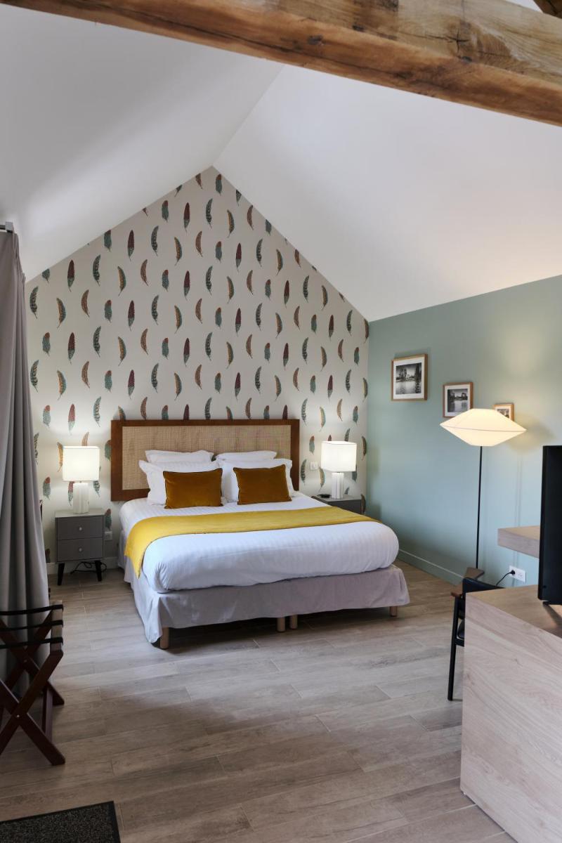 Un ou plusieurs lits dans un hébergement de l'établissement Domaine Du Roncemay - Hôtel, Restaurants, Spa & Golf