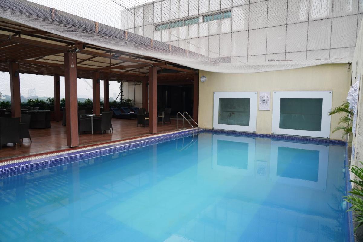 a large swimming pool with blue water in a building at Fortune Select JP Cosmos, Bengaluru - Member ITC Hotels' Group in Bengaluru