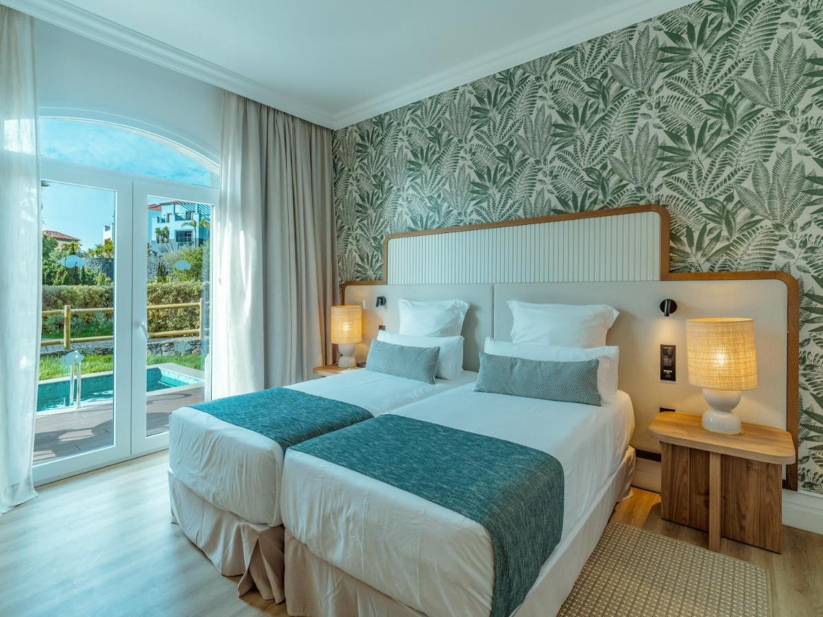 Uma cama ou camas num quarto em Dreams Madeira Resort Spa & Marina