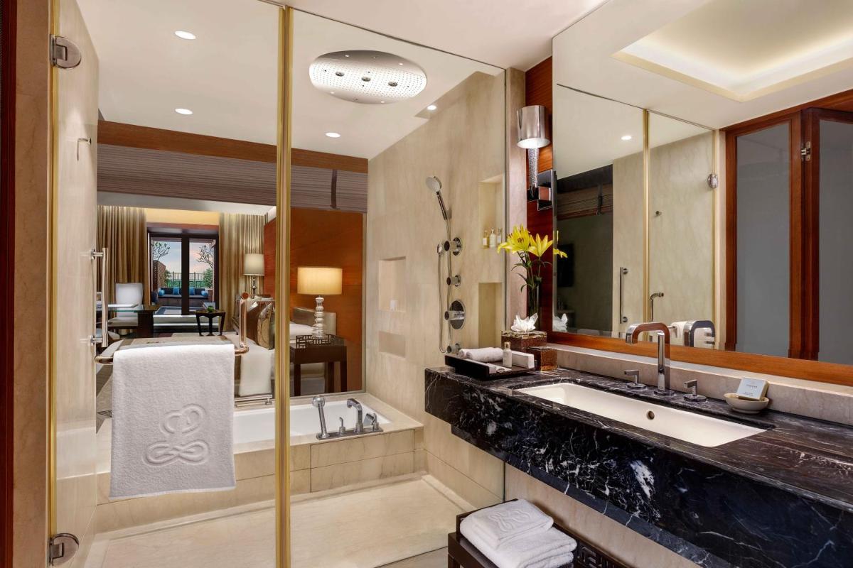 a bathroom with a large sink and a mirror at The Leela Ambience Gurugram Hotel & Residences - The Luxury Urban Sanctuary in Gurgaon